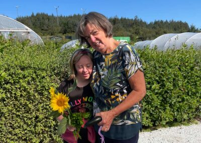 A mother and daughter with sunflower in allotments