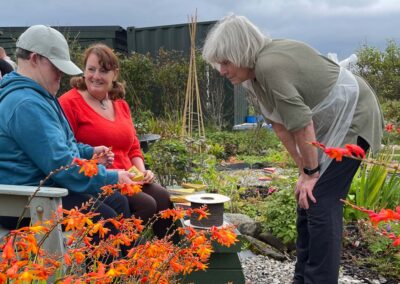 Three people chatting in a garden