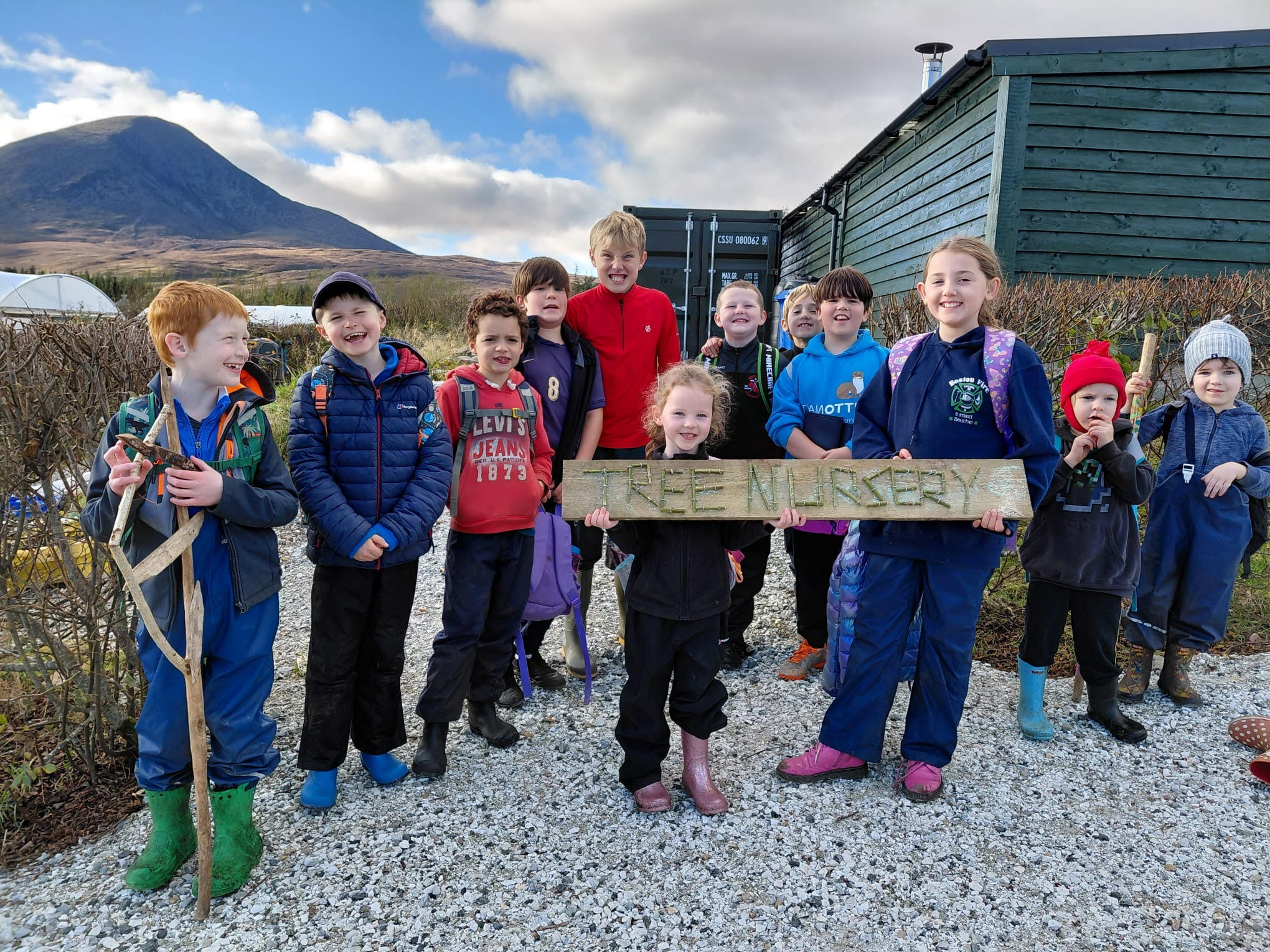 Corry Capers nursery sign A group of children with a sign saying Tree Nursery