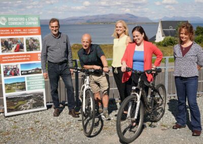 a group of people with bikes and a banner reading Broadford and Strath Community Company