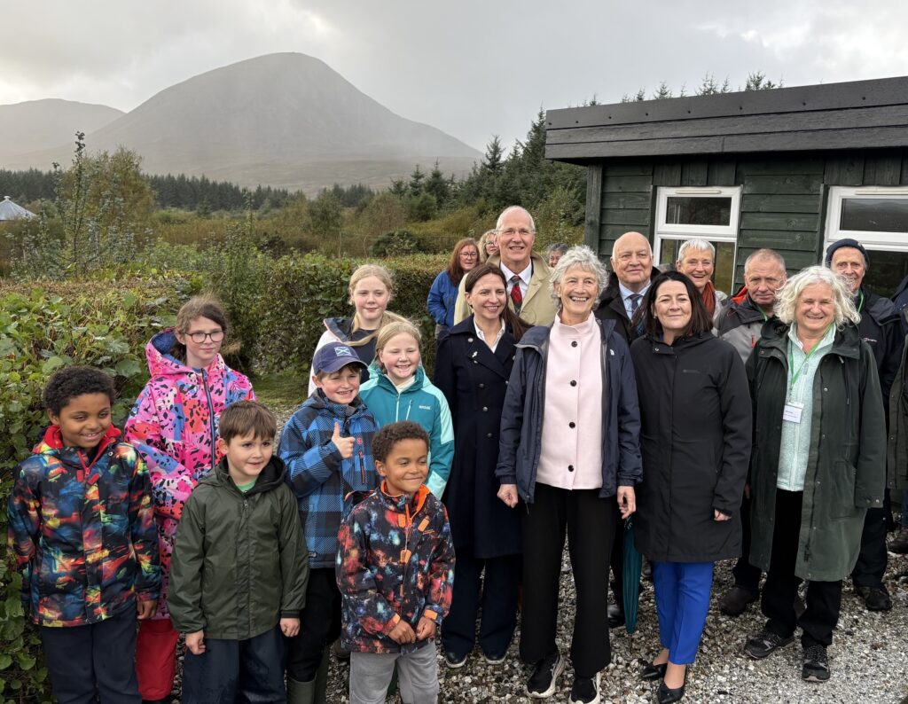 A group of people in front of Growers Hub wooden cabin